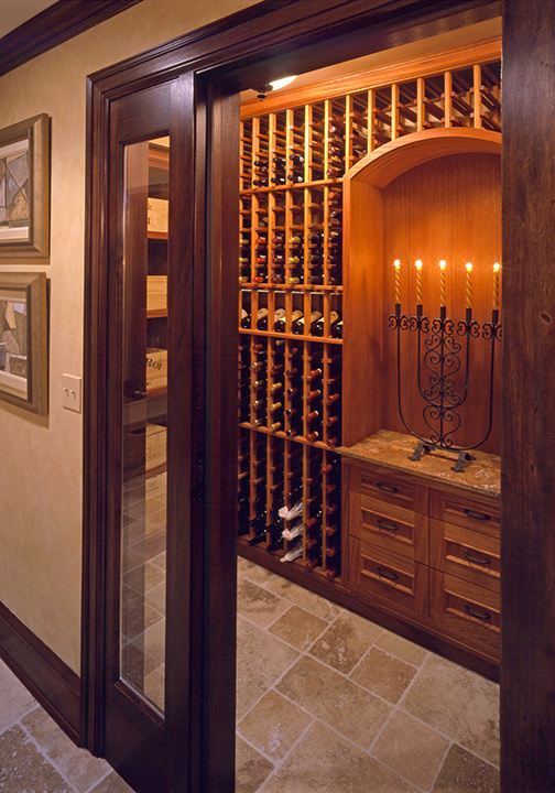 Intimate wine room with warm wood finishes and candlelight, designed by MA Peterson in Twin Cities