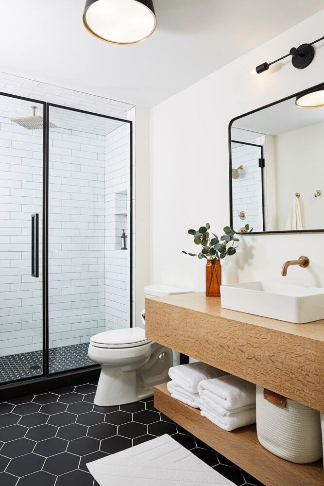 Bathroom remodel featuring black hexagon tiles and glass shower by MA Peterson in the Twin Cities