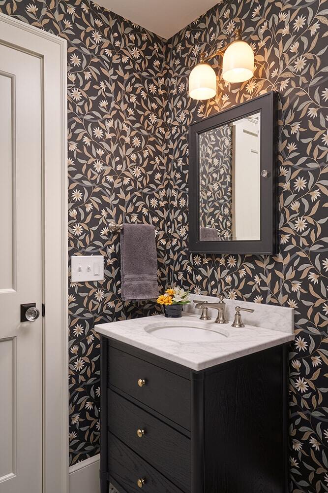 Chic bathroom remodel with floral wallpaper and black vanity by MA Peterson in Twin Cities