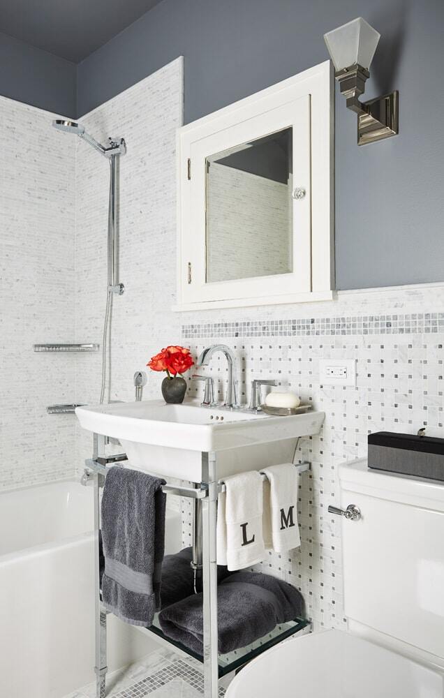 Classic white bathroom with pedestal sink and chrome fixtures, remodeled by MA Peterson in the Twin Cities