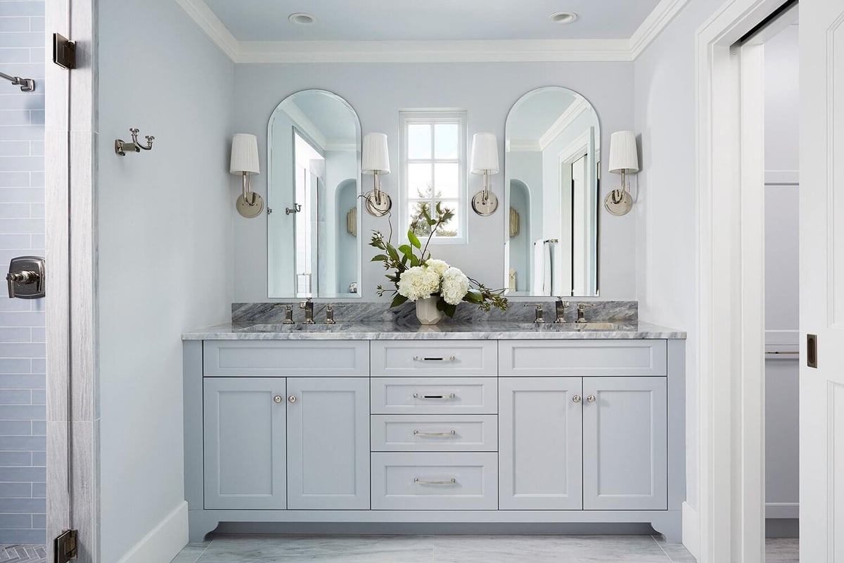 Light blue bathroom vanity with marble countertop in a Twin Cities remodel project by MA Peterson