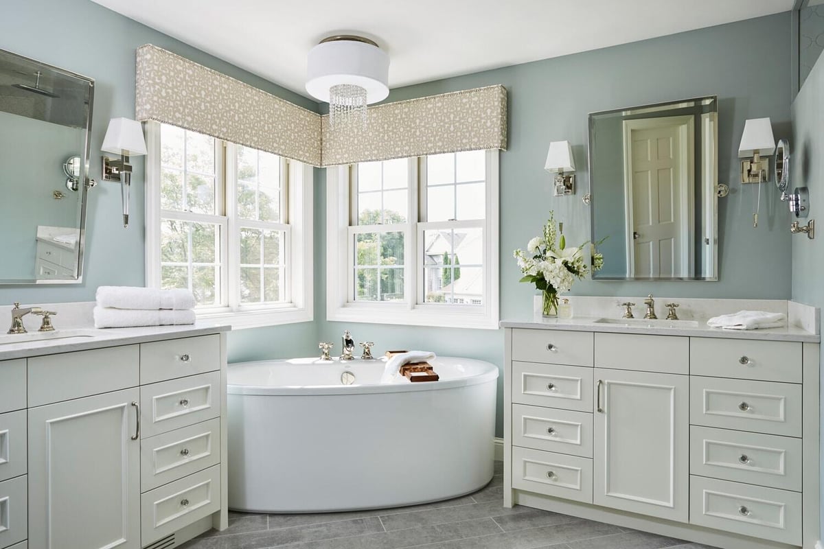 Luxurious bathroom with soaking tub and double vanities by MA Peterson in the Twin Cities