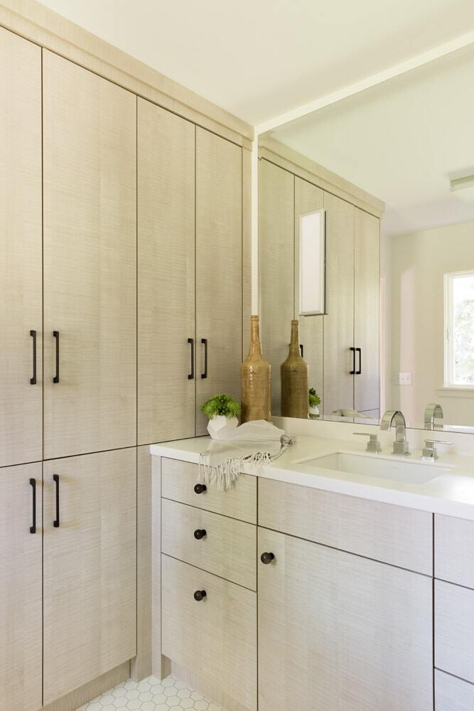 Sleek bathroom with light wood cabinetry by MA Peterson in the Twin Cities