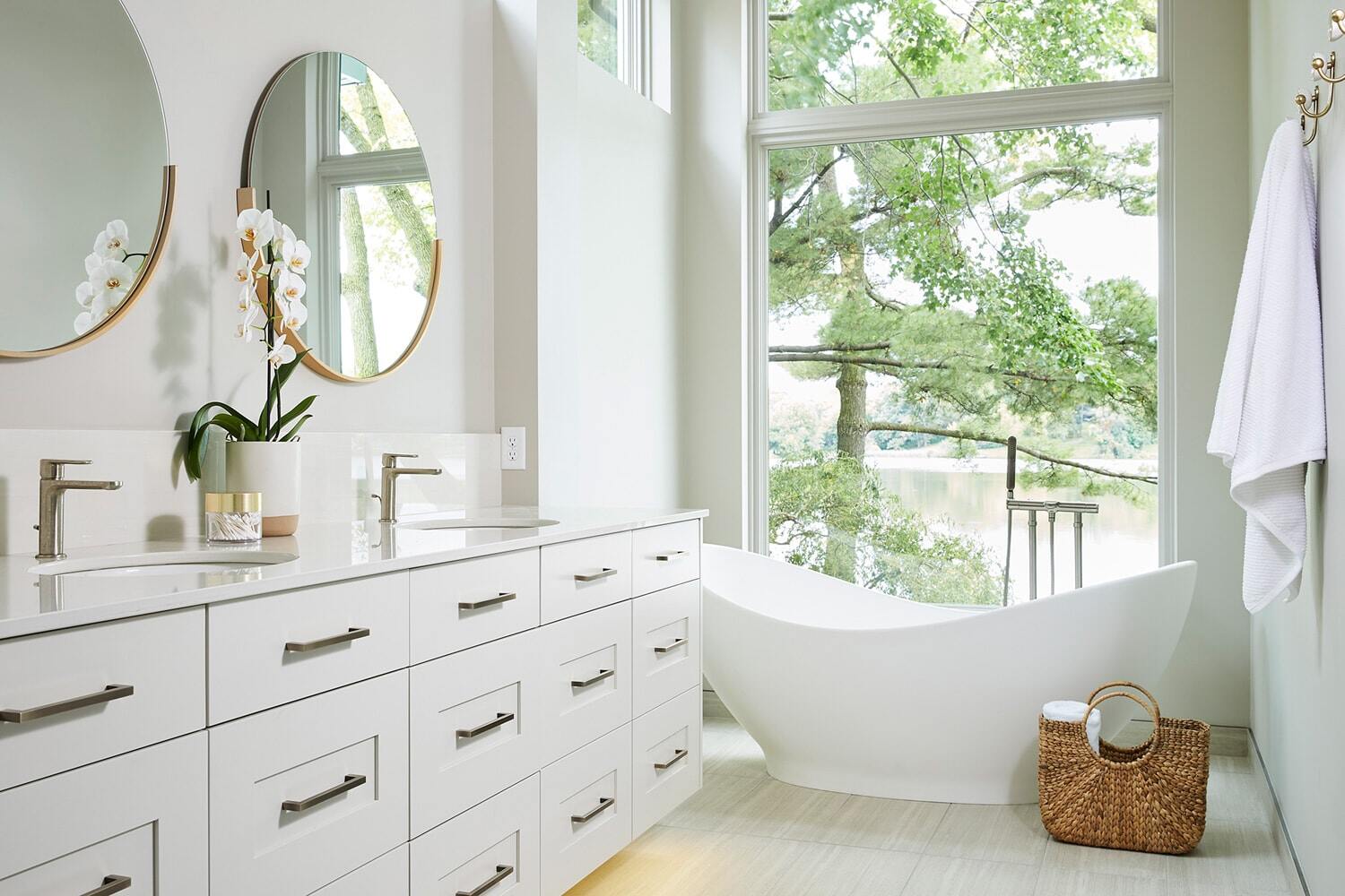 Spa-like bathroom with a freestanding tub and scenic view, by MA Peterson in Twin Cities