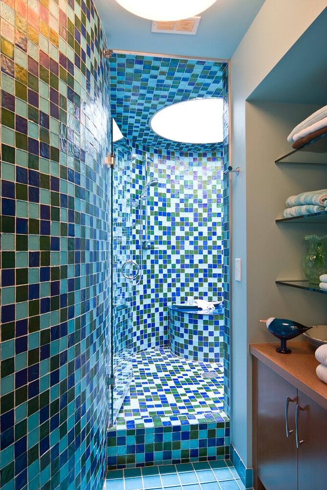 Vibrant blue and green tiled shower designed by MA Peterson in a Twin Cities bathroom remodel