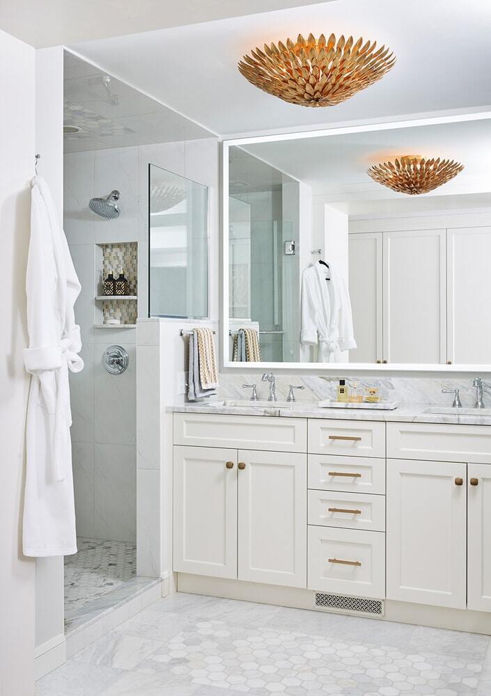 White bathroom with gold fixtures and a spacious vanity by MA Peterson in a Twin Cities remodel