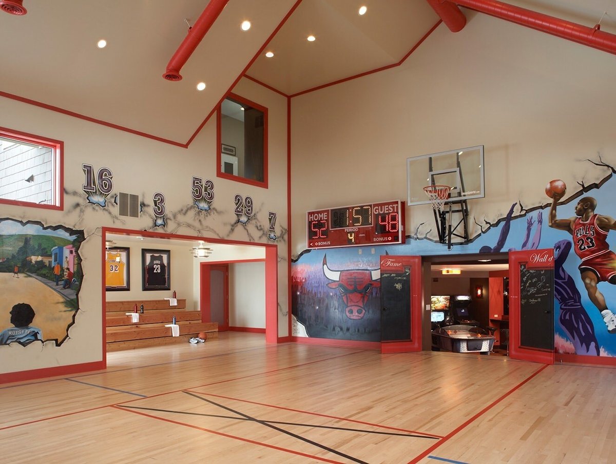 Indoor basketball court with Chicago Bulls mural and scoreboard, designed by MA Peterson in the Twin Cities