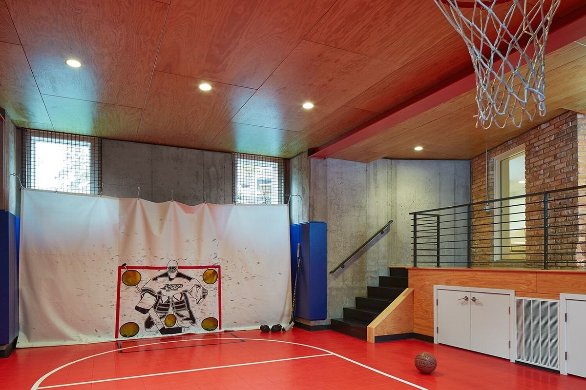 Indoor basketball court with hockey practice setup, designed by MA Peterson in the Twin Cities