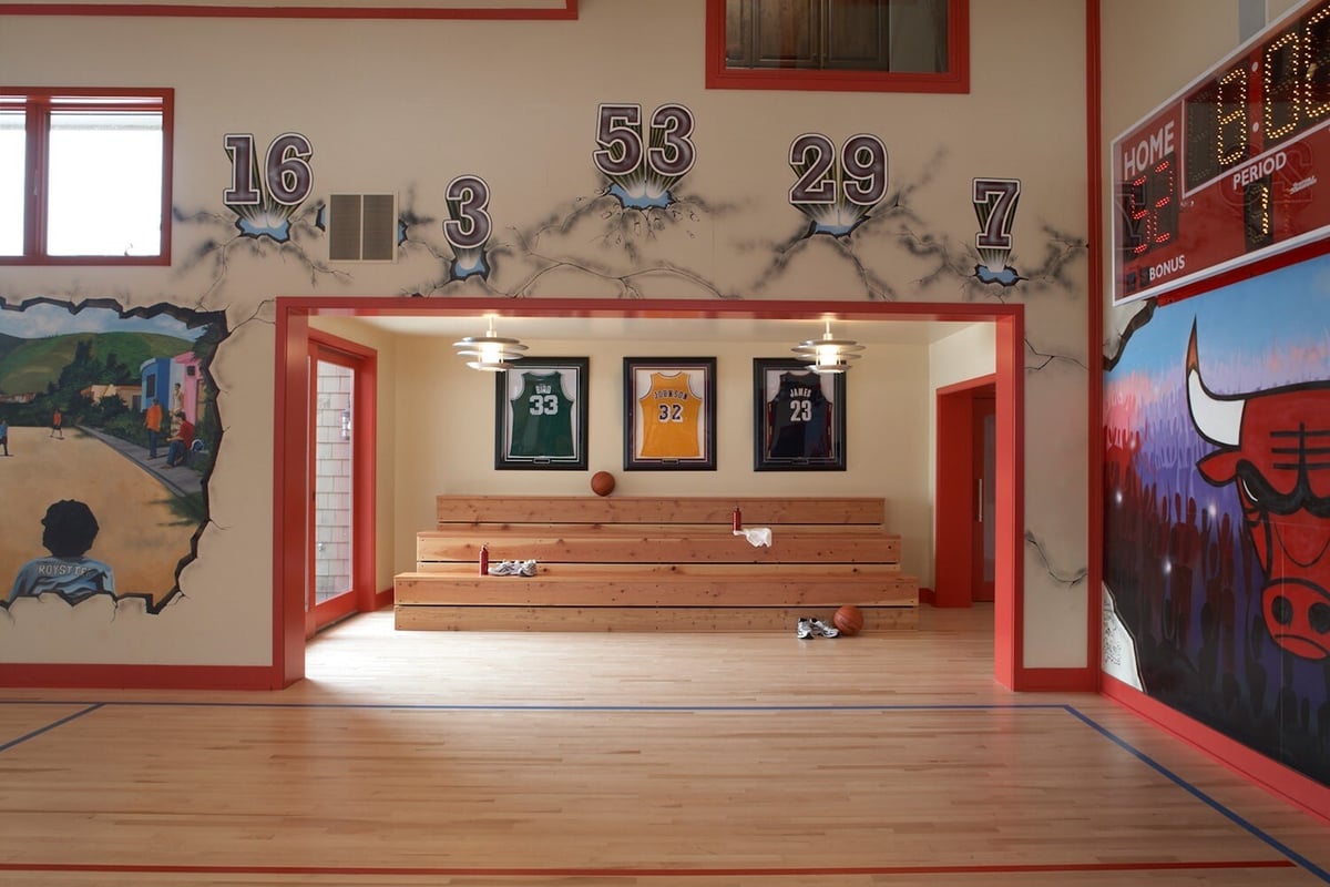 Indoor basketball court with wall murals and sports memorabilia, designed by MA Peterson in the Twin Cities