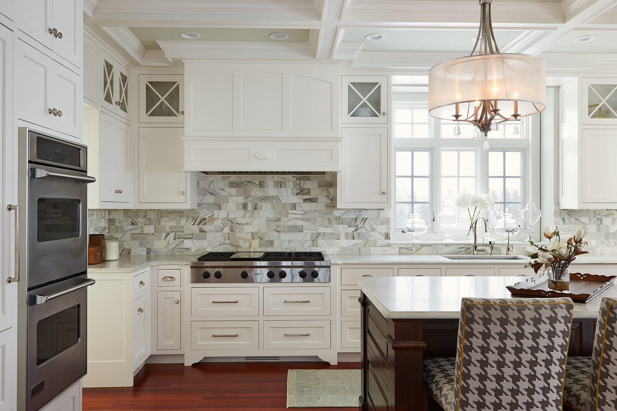 Classic kitchen remodel with white cabinets and marble backsplash by MA Peterson in the Twin Cities