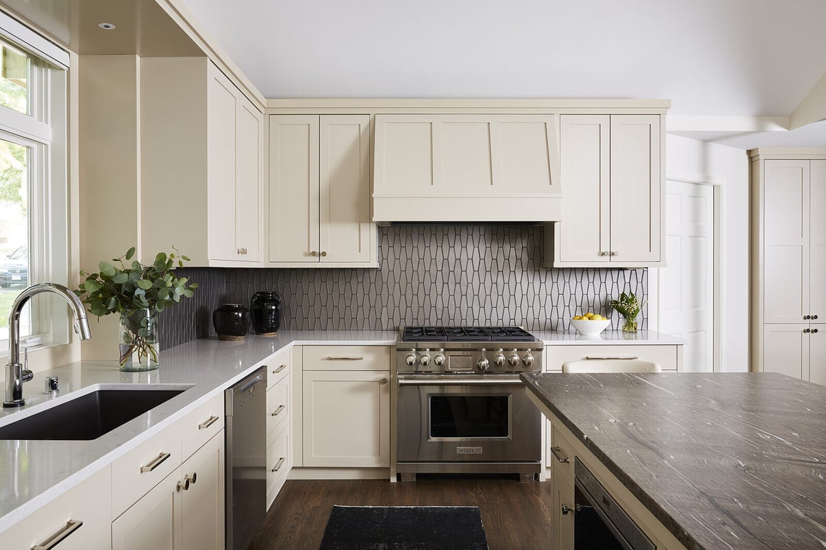 Elegant kitchen remodel with beige cabinets and geometric backsplash by MA Peterson in the Twin Cities