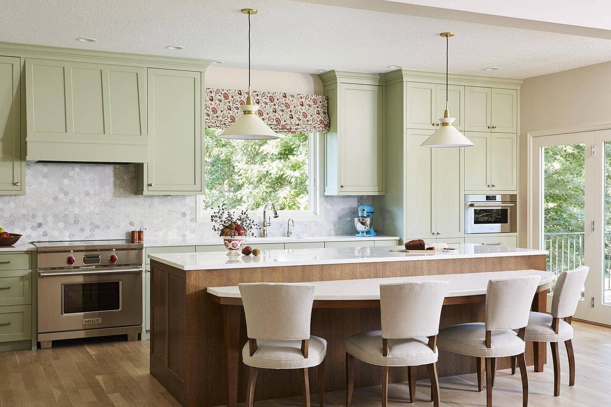 Elegant kitchen with mint green cabinets and a large central island by MA Peterson in the Twin Cities