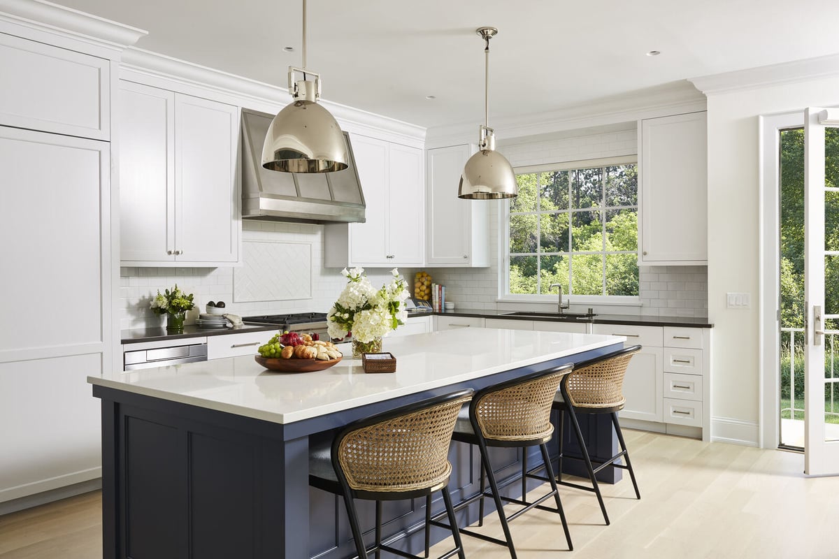 Elegant white kitchen remodel with large island and stainless steel appliances by MA Peterson in Twin Cities