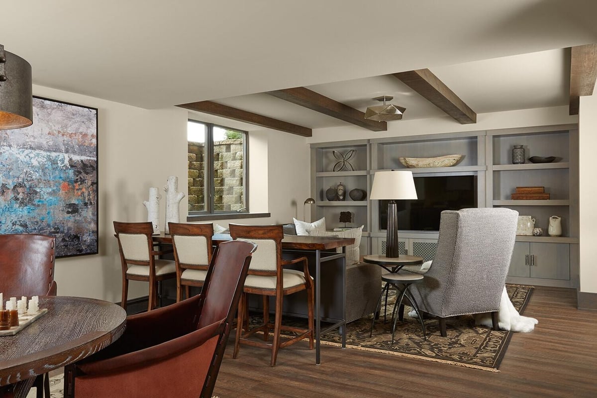 Cozy lower level family room with wooden beams by MA Peterson in the Twin Cities