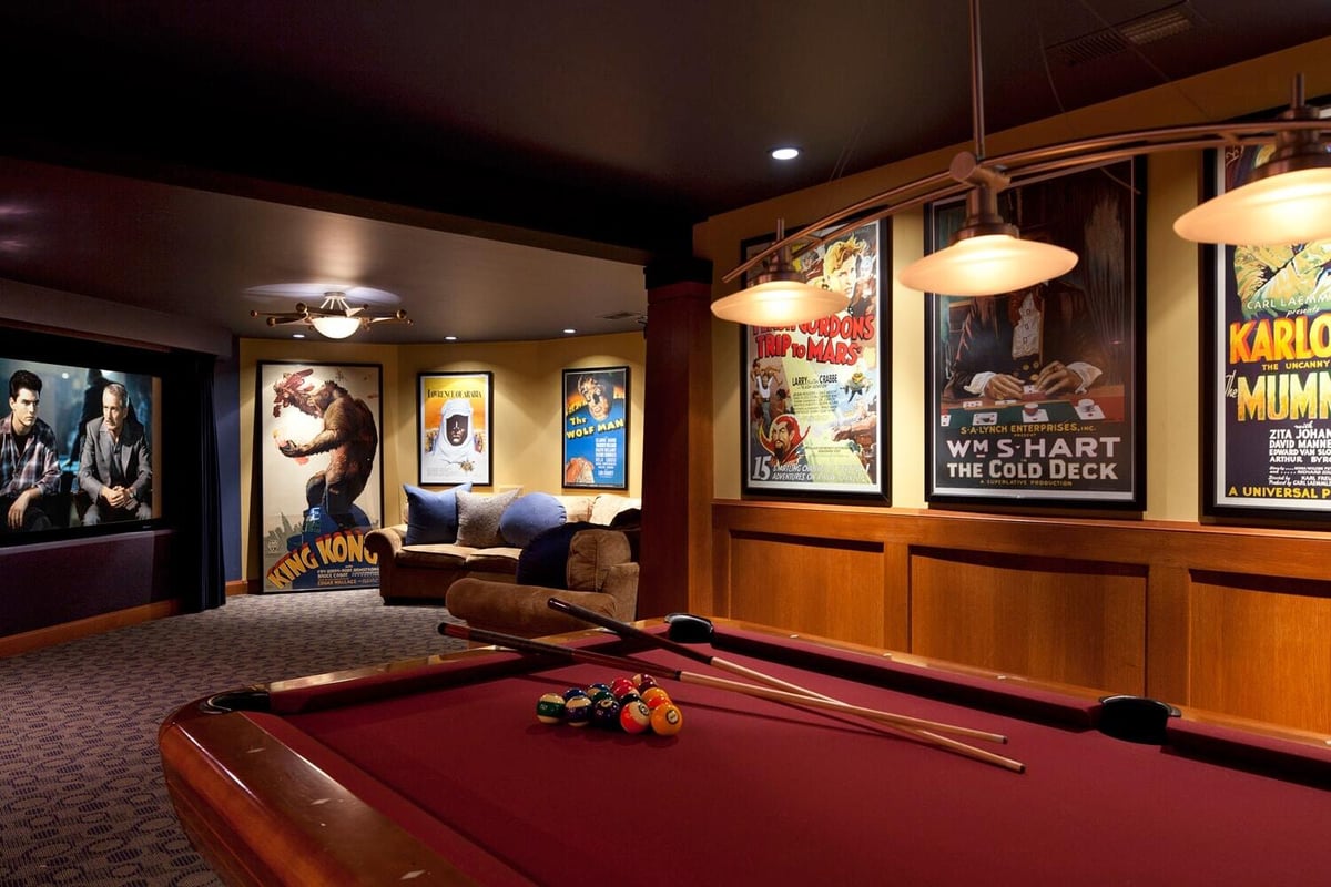 Home theater with vintage movie posters in a remodeled lower level by MA Peterson in the Twin Cities