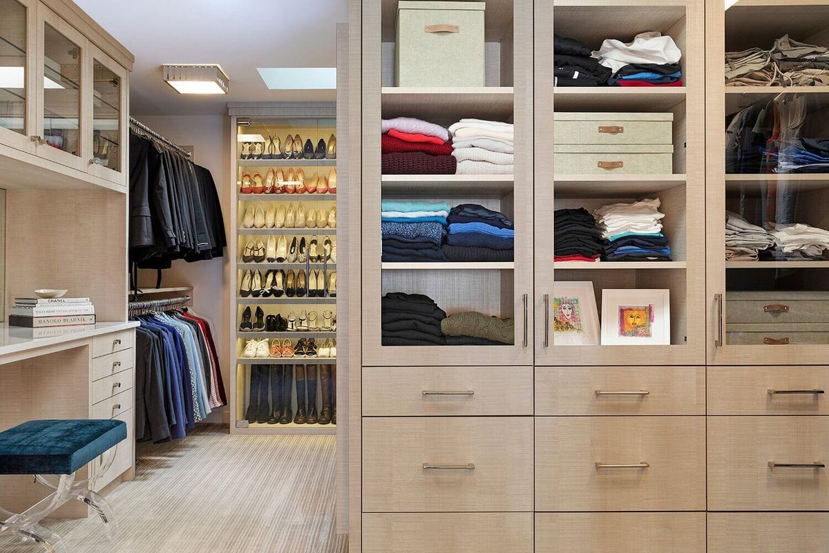 Modern walk-in closet design with ample storage and elegant decor, featured in a custom home by MA Peterson, Twin Cities