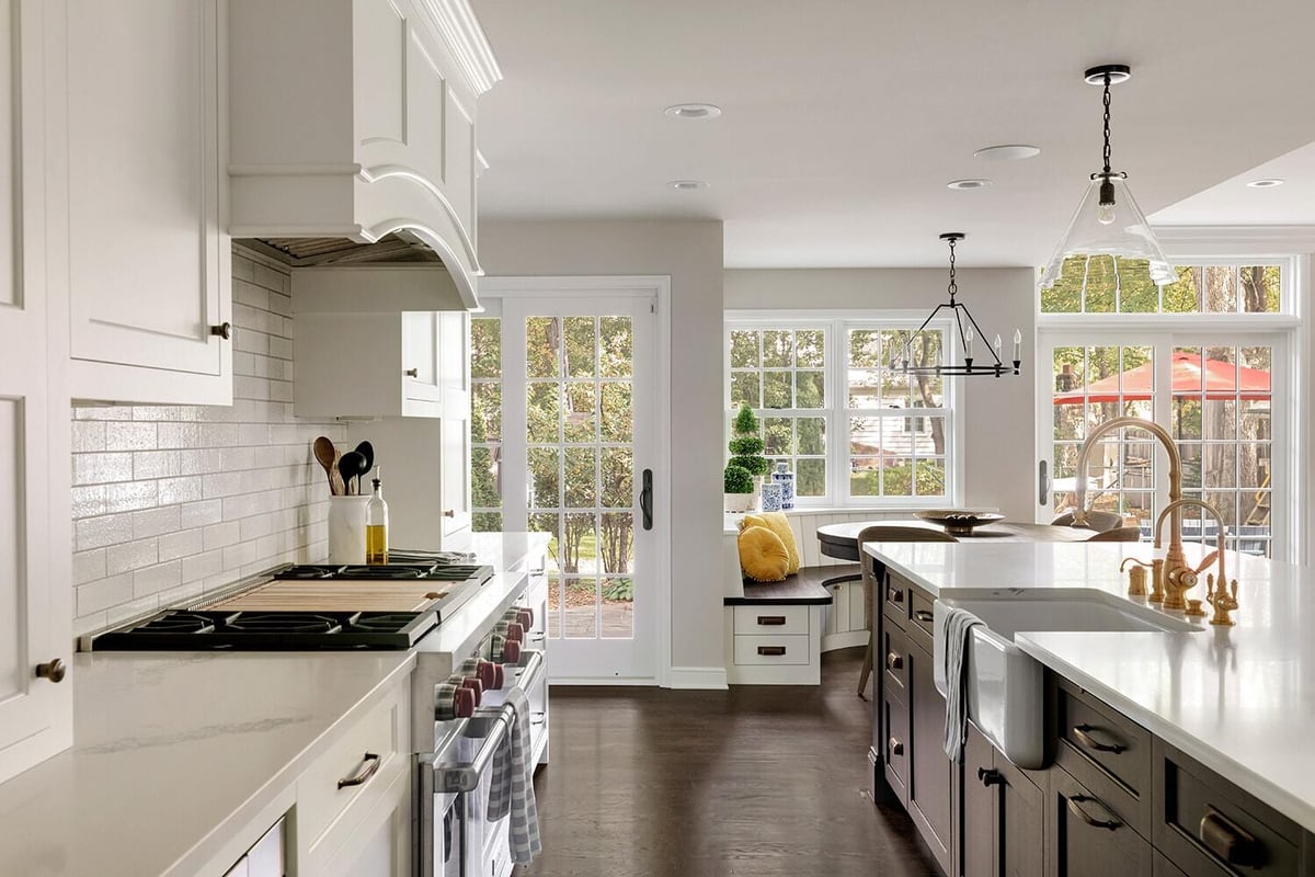 Bright kitchen with central island and dining area, remodeled by MA Peterson in Twin Cities