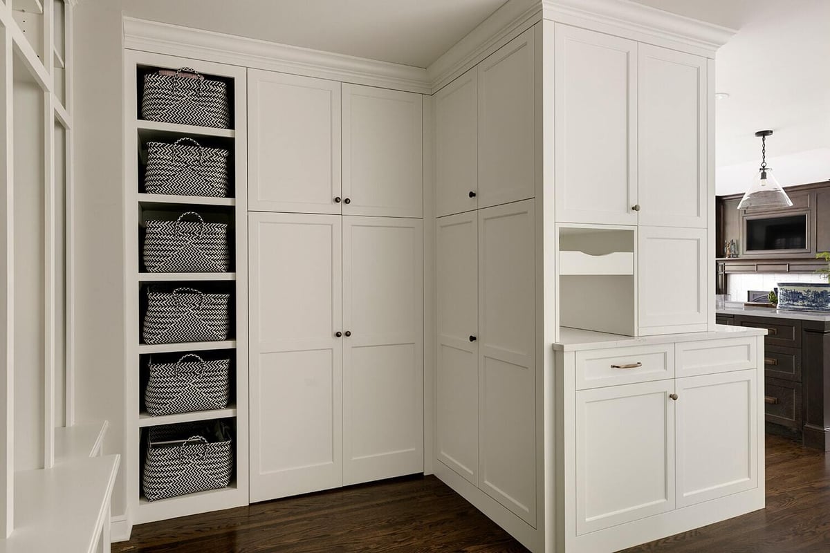 Functional mudroom with custom cabinetry and storage baskets by MA Peterson, Twin Cities