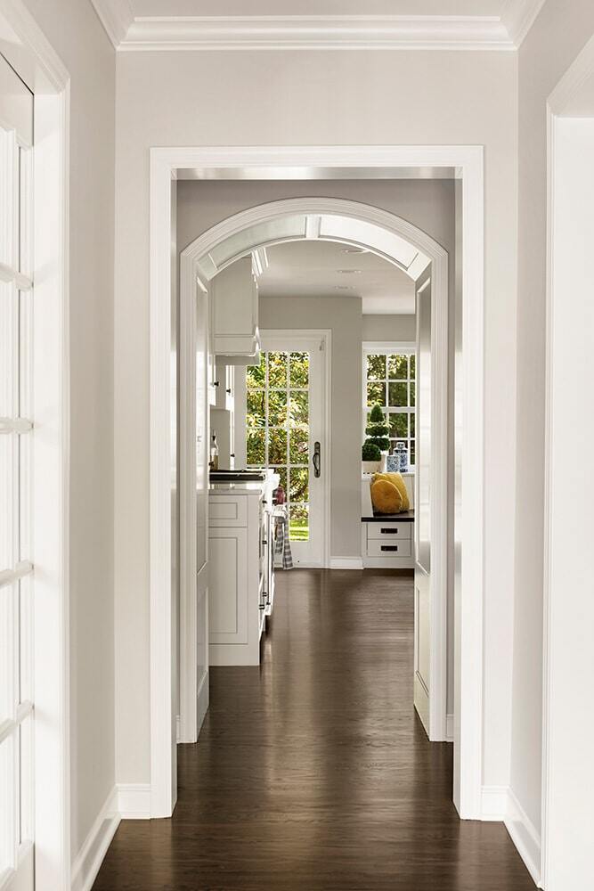 Hallway leading to a bright kitchen in a home remodeled by MA Peterson in Twin Cities