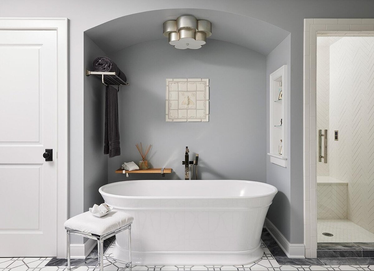 Elegant bathroom with freestanding tub and arched alcove, remodeled by MA Peterson in Twin Cities