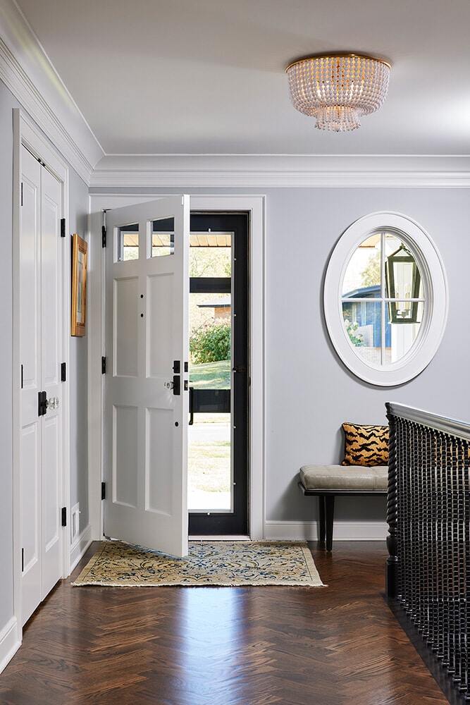 Elegant entryway with open door and decorative bench, remodeled by MA Peterson in Twin Cities