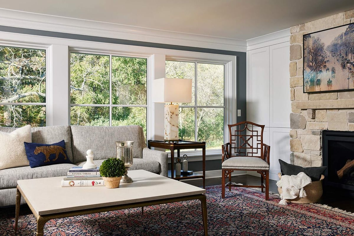 Inviting living room with large windows and cozy seating, remodeled by MA Peterson in Twin Cities