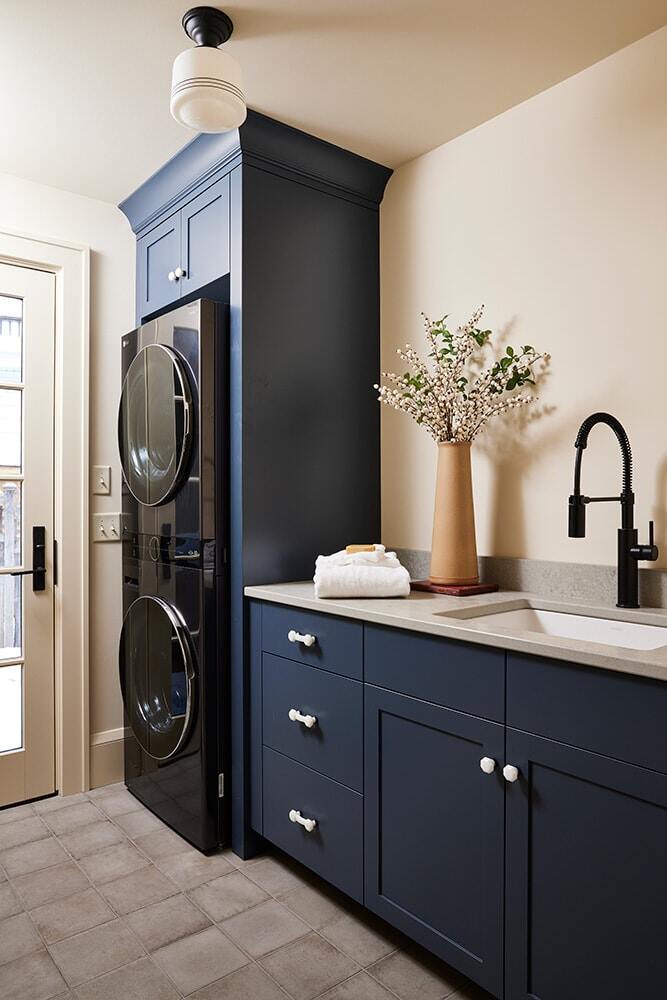 Blue-themed laundry room with modern appliances, designed by MA Peterson in the Twin Cities
