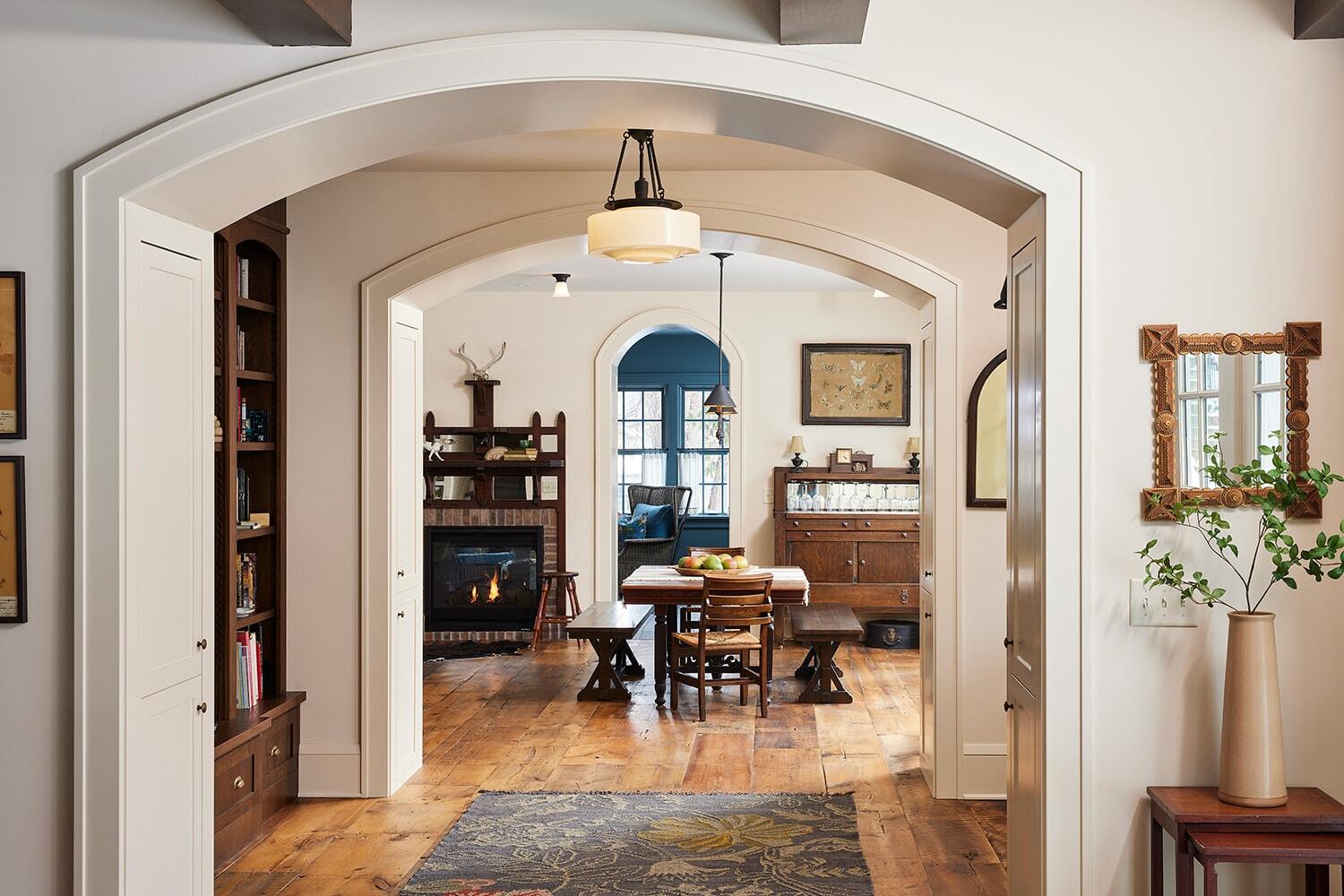 Interior view of a warm eclectic vintage living room with a fireplace, designed by MA Peterson in Twin Cities