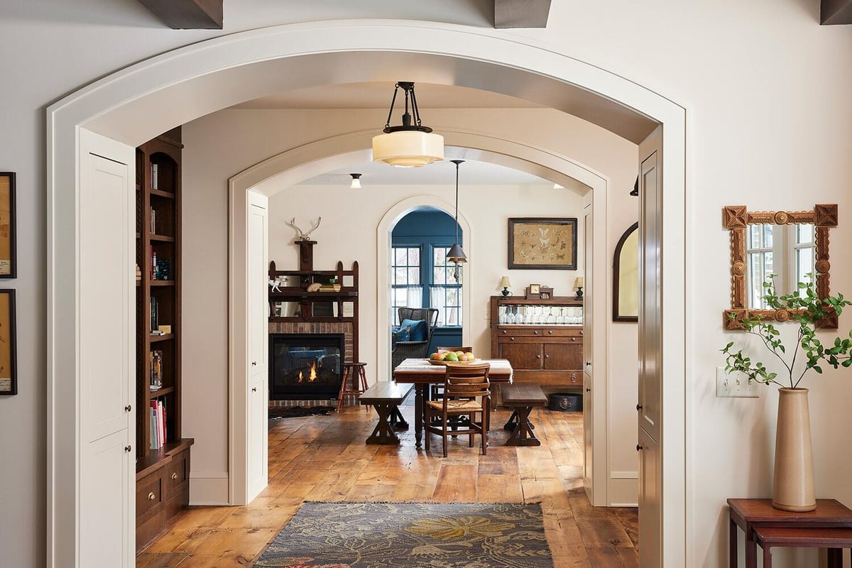 Interior view of a warm eclectic vintage living room with a fireplace, designed by MA Peterson in Twin Cities