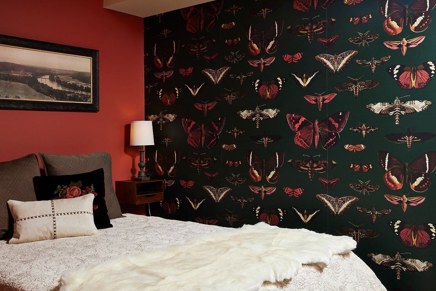 Twin Cities bedroom by MA Peterson showcasing butterfly wallpaper and vintage-style furnishings