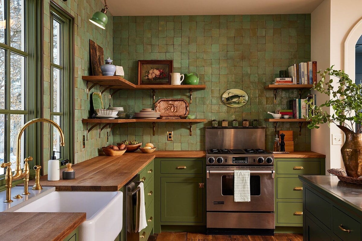 Vintage kitchen with green cabinets, wooden shelves, and a farmhouse sink, part of MA Petersons Twin Cities project