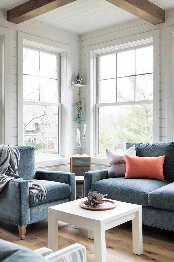 Bright sunroom corner with comfortable seating and a modern design in Twin Cities by MA Peterson