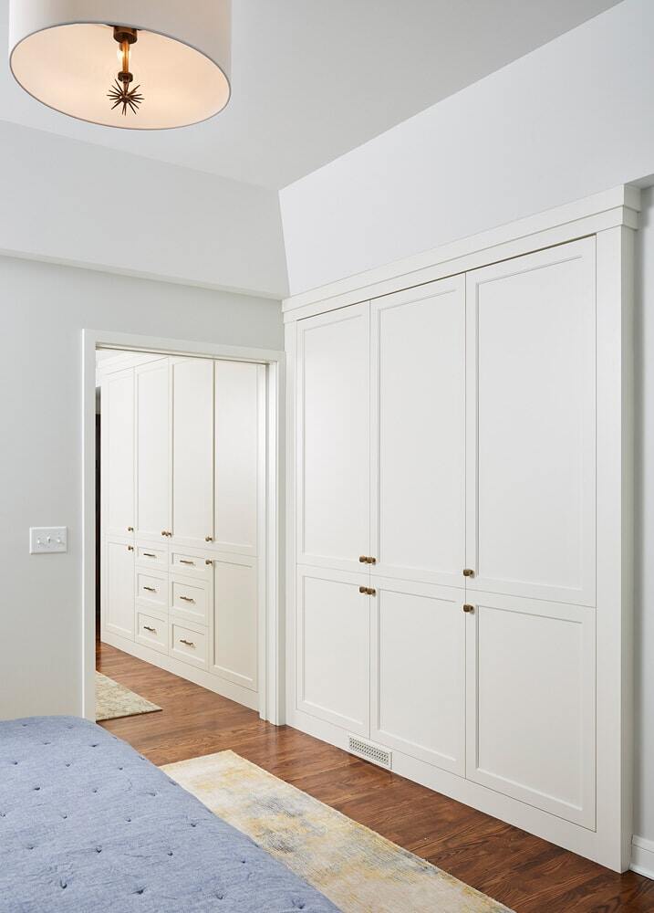 Hallway with built-in cabinetry leading to a bedroom in a remodeled home by MA Peterson in the Twin Cities