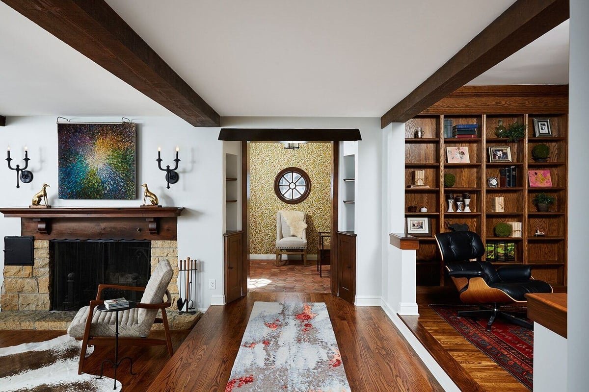 Living area with stone fireplace and built-in shelving in a home remodeled by MA Peterson in the Twin Cities