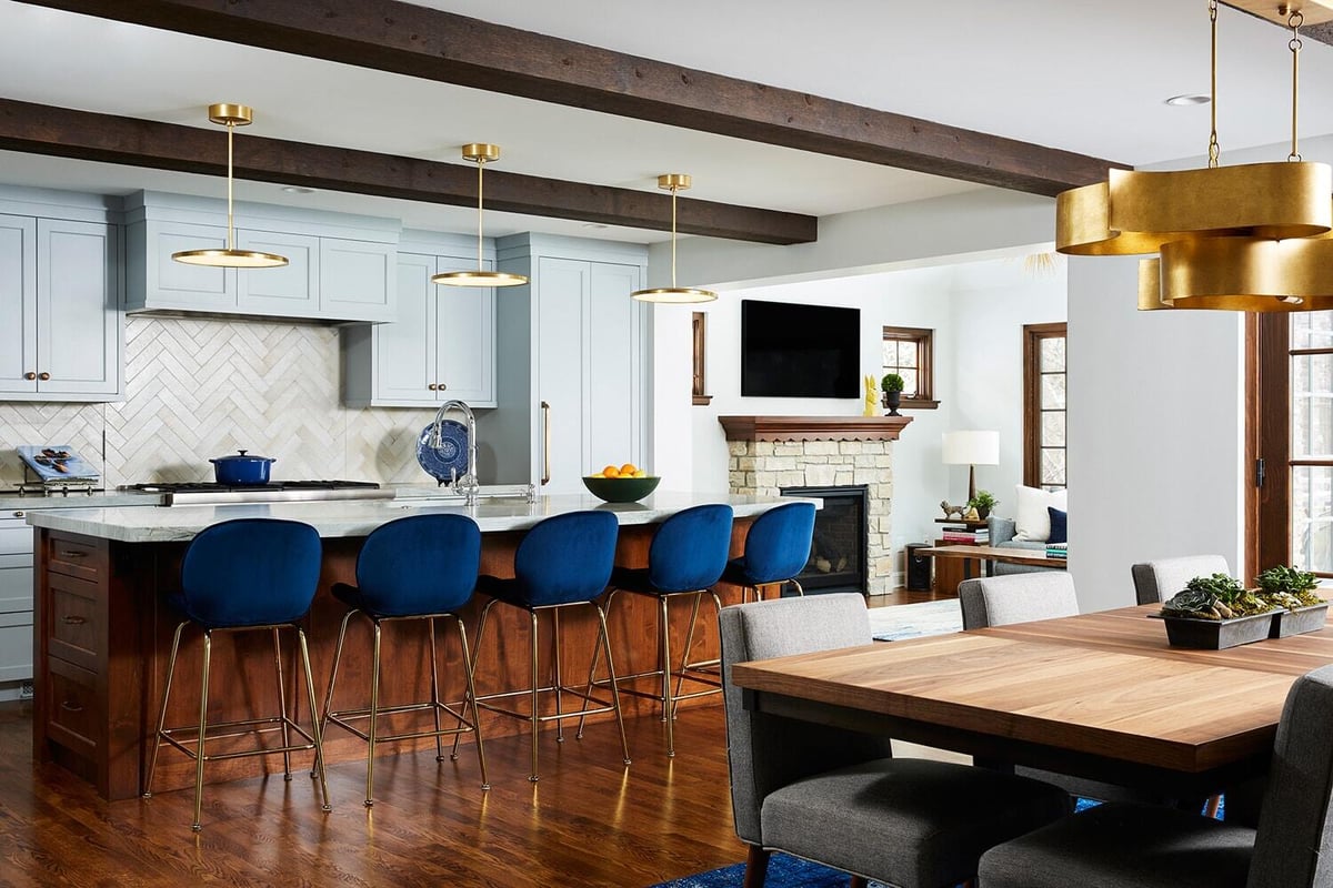 Stylish kitchen and dining area featuring blue bar stools, remodeled by MA Peterson in the Twin Cities