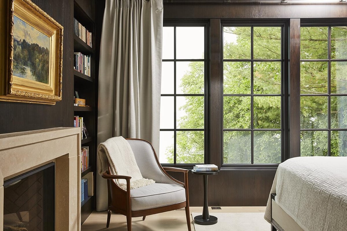 Reading nook in bedroom with scenic view in Coastal Chic home, remodeled by MA Peterson in Twin Cities