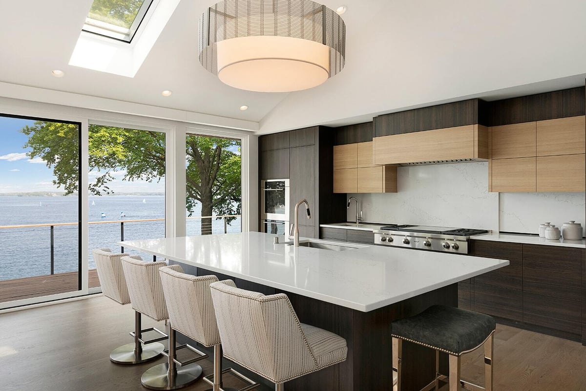 Modern kitchen design featuring an island and wooden cabinetry, completed by MA Peterson in Twin Cities