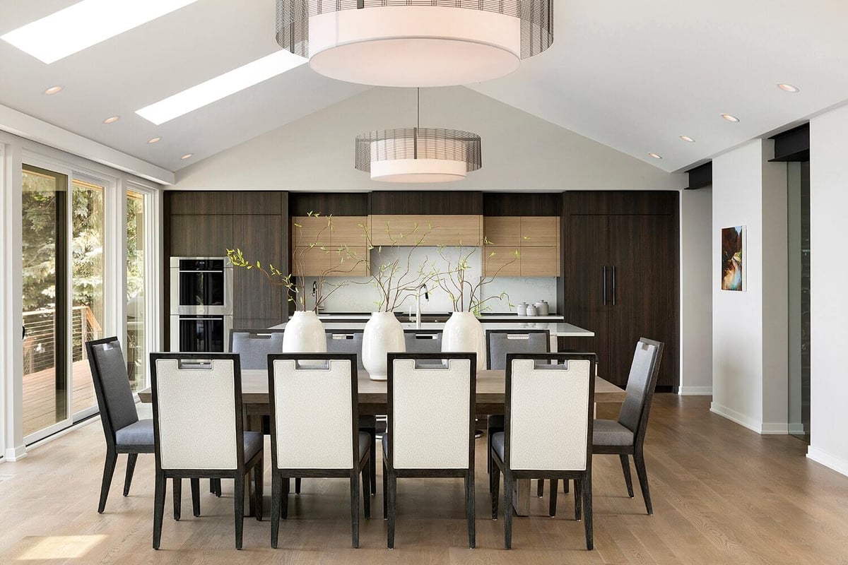 Sleek kitchen with island seating and lake views, designed by MA Peterson in Twin Cities