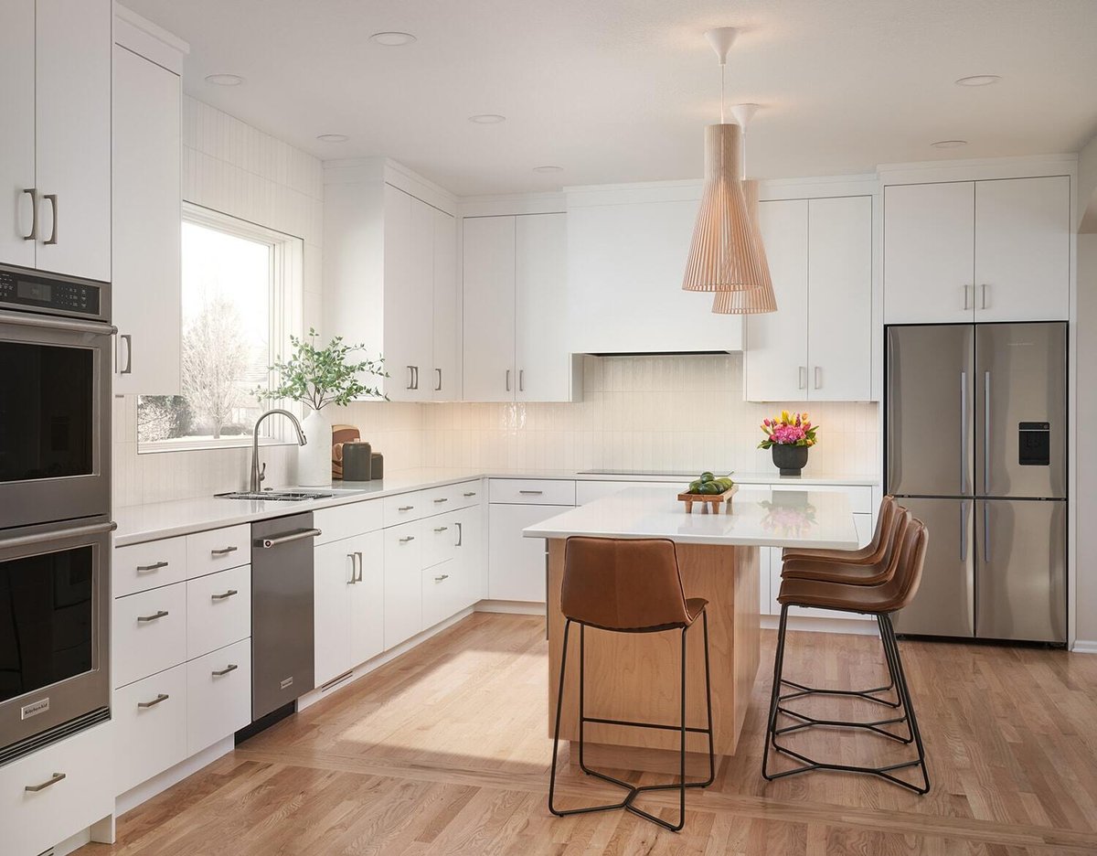 Bright white kitchen with island and pendant lights in Crafting Warmth in Modern home, MA Peterson Twin Cities