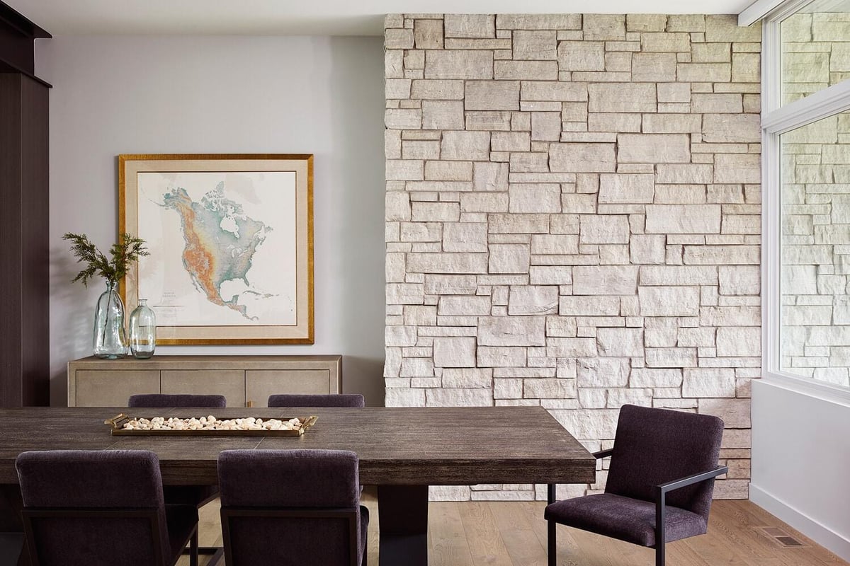 Contemporary dining area with stone accent wall and natural decor, MA Peterson, Twin Cities