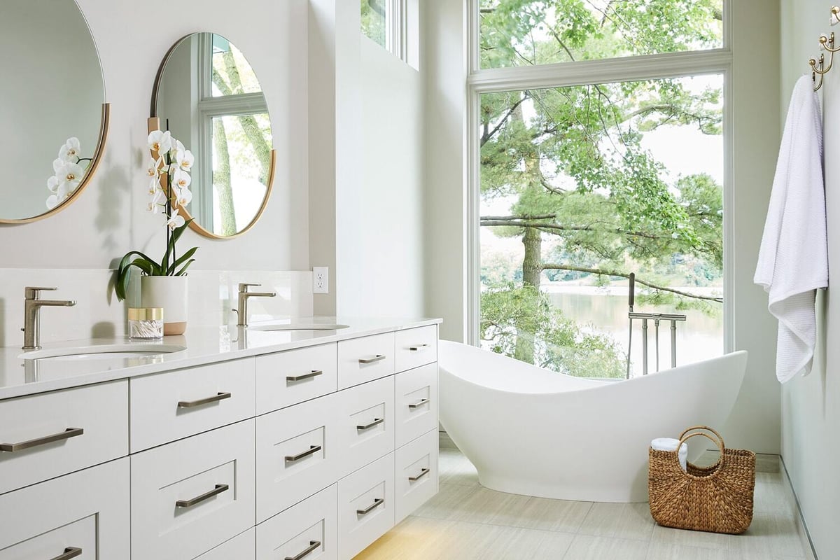 Dual vanity bathroom with lake view in Lake Cornelia home by MA Peterson, Twin Cities