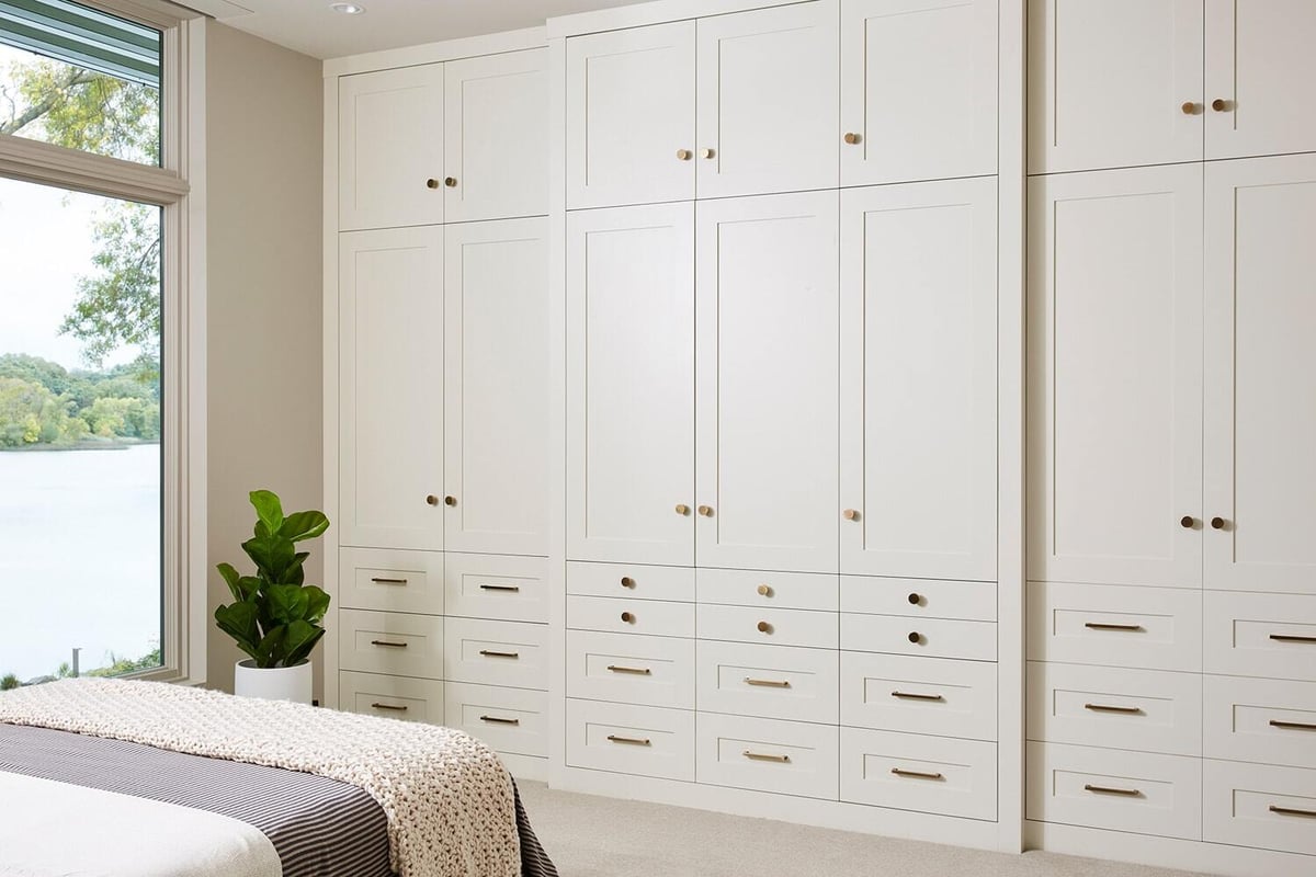 Modern bedroom with extensive cabinetry and lake view, remodeled by MA Peterson in Twin Cities