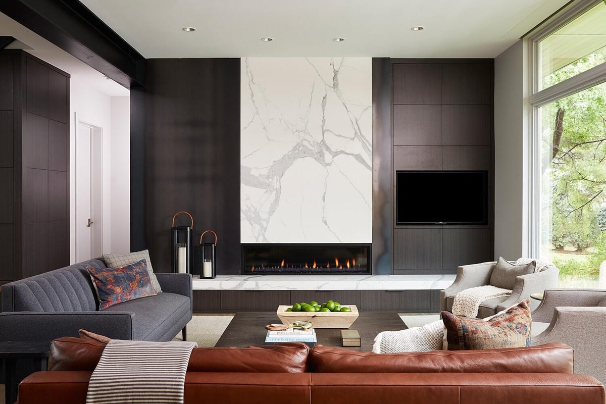Modern living room featuring marble fireplace and large windows, MA Peterson, Twin Cities