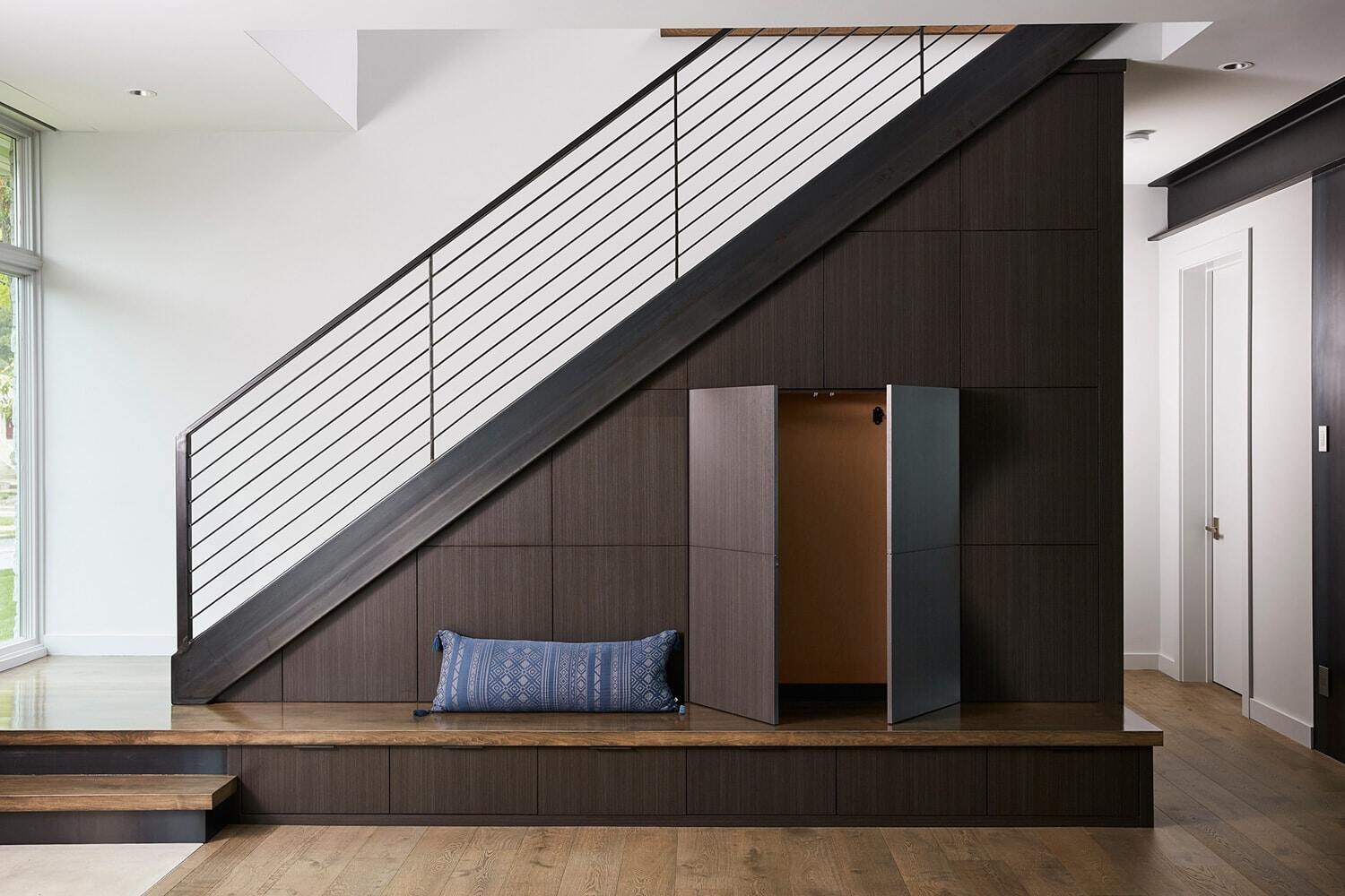 Under-stair storage with bench in contemporary Lake Cornelia home by MA Peterson, Twin Cities