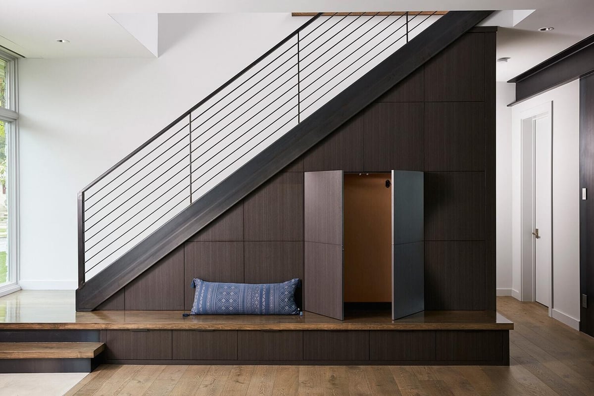 Under-stair storage with bench in contemporary Lake Cornelia home by MA Peterson, Twin Cities