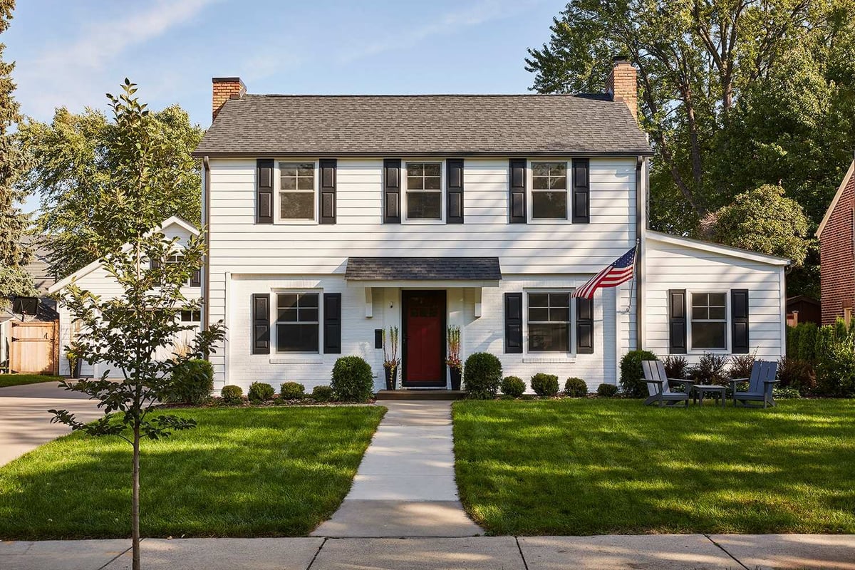 Front view of a remodeled white house in Twin Cities by MA Peterson