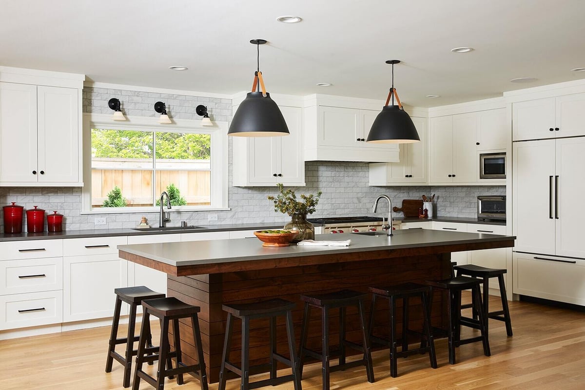 Renovated kitchen by MA Peterson in Twin Cities with white cabinetry and large central island