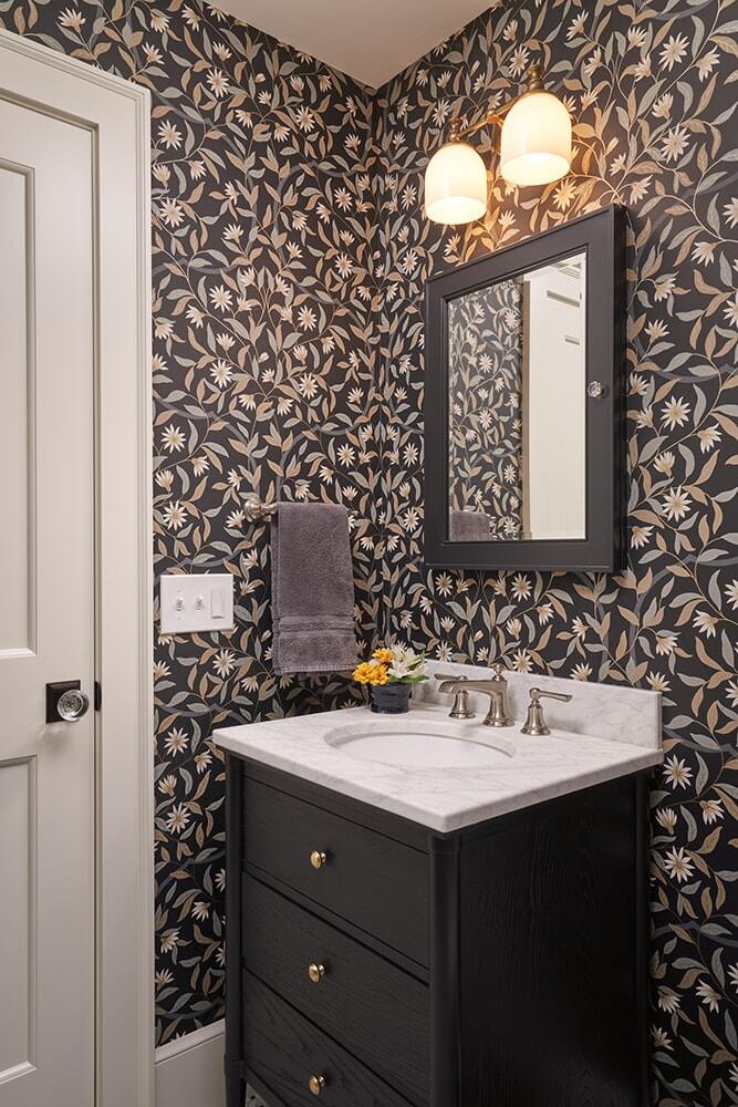 Bathroom with floral wallpaper and a marble sink by MA Peterson in Twin Cities