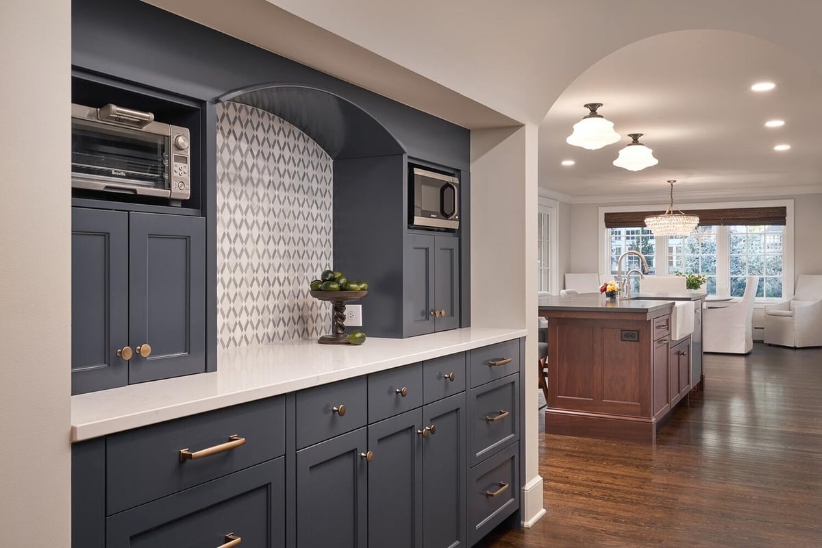 Built-in navy blue cabinetry with a white countertop with emphasis on style and decor by MA Peterson in Twin Cities