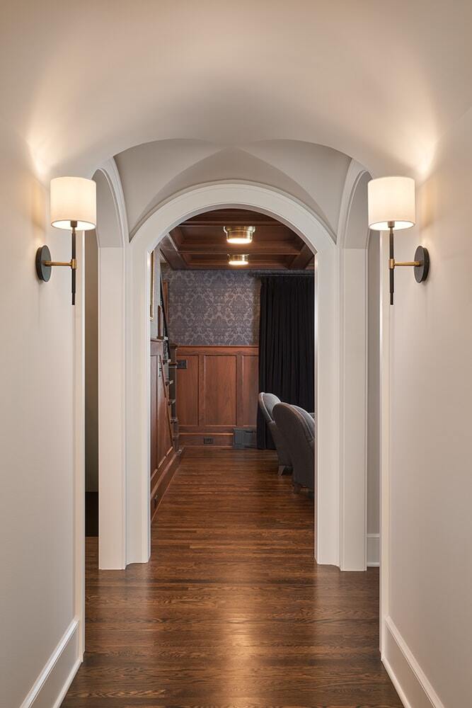 Hallway with arched doorways and hardwood floors with emphasis on style and decor by MA Peterson in Twin Cities​